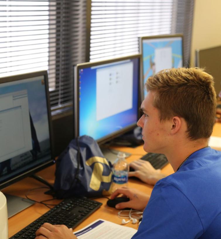 Summer camp participant sitting at computer