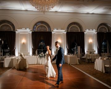 bride and groom dancing in ballroom