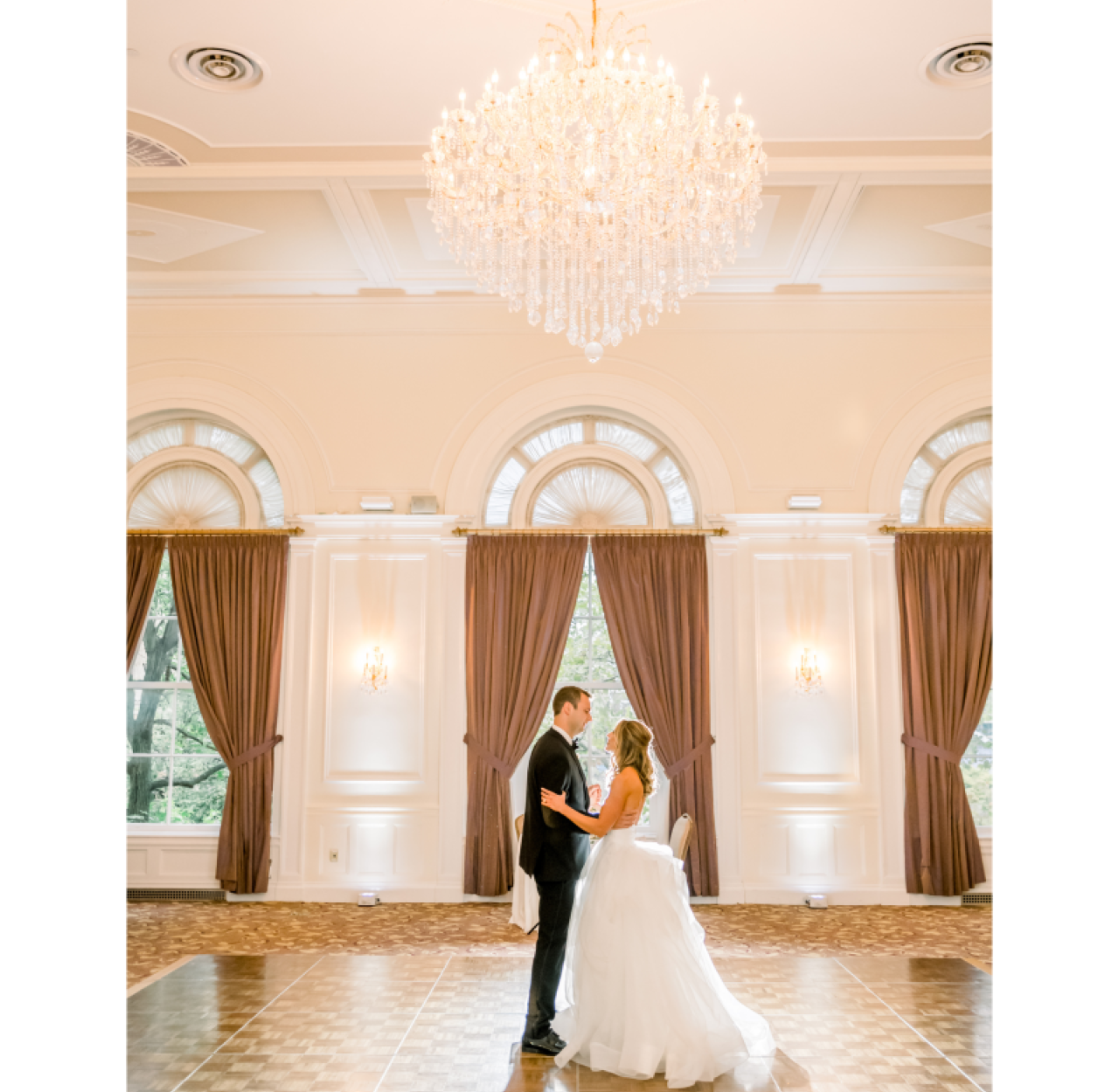 Bride and Groom dancing under chandelier in ballroom B